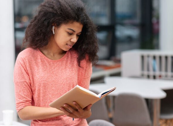 Girl reading a book for IELTS reading preparation