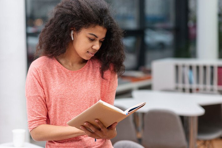 Girl reading a book for IELTS reading preparation